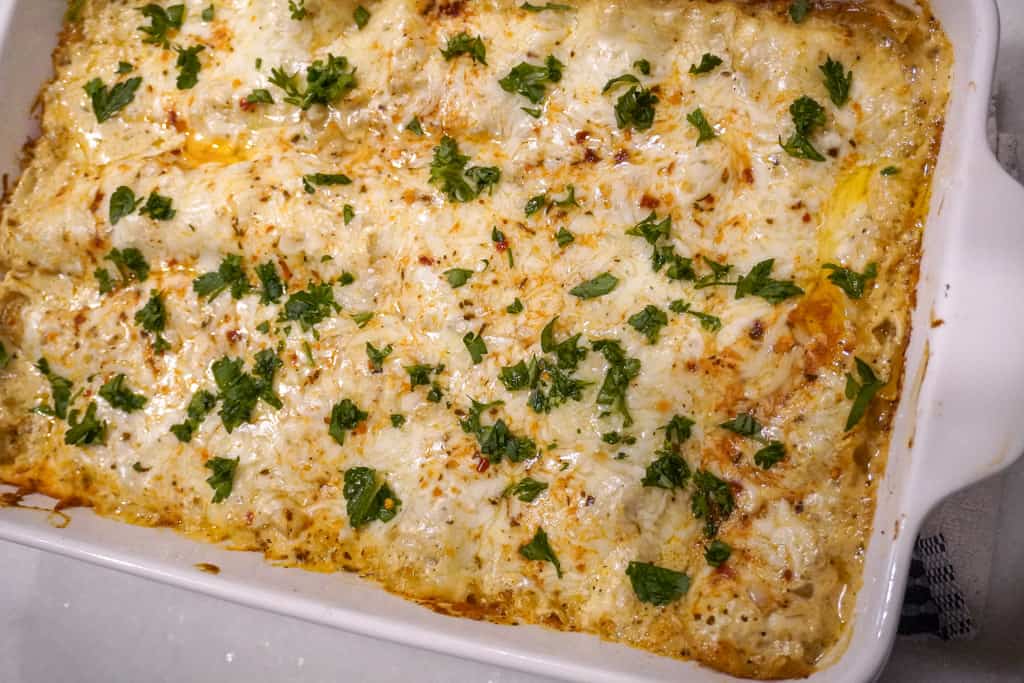 casserole dish filled with chicken alfredo lasagna