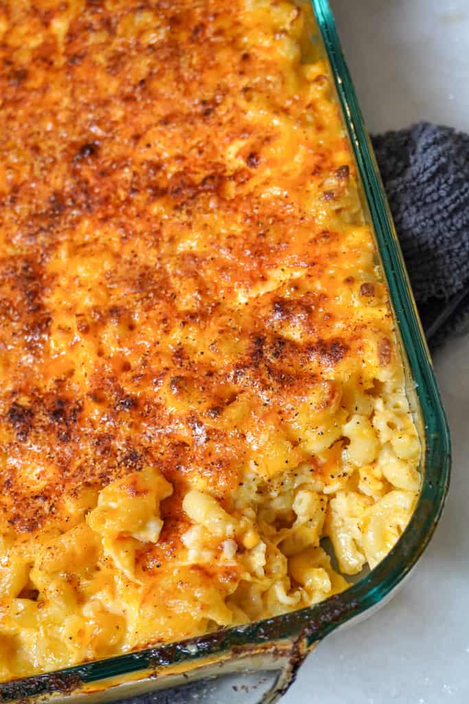 close up view of baked southern macaroni and cheese with a corner piece missing