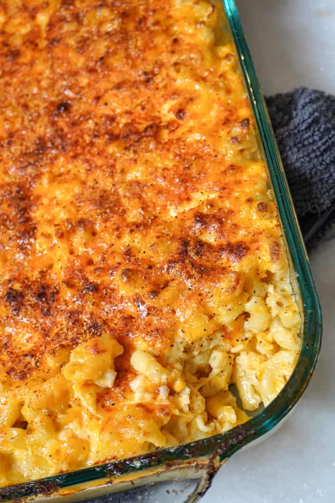 Southern macaroni and cheese close up view of baked southern macaroni and cheese with a corner piece missing