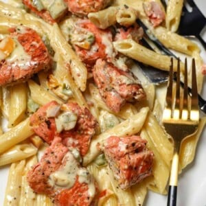 close up view of a plate of lemon pepper salmon with pasta