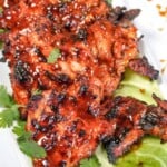 close up view of grilled chicken thighs plated