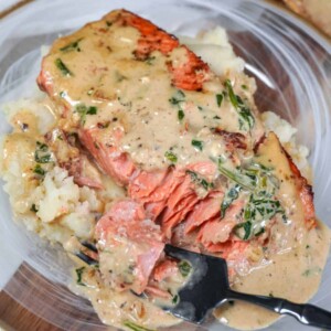 plated marry me salmon with. fork inserted to show flaky, tender center