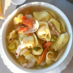 overhead view of a bowl of chicken tortellini soup