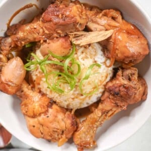 close up view of a bowl of Filipino chicken adobo with rice