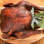 a whole smoked turkey on a cutting board