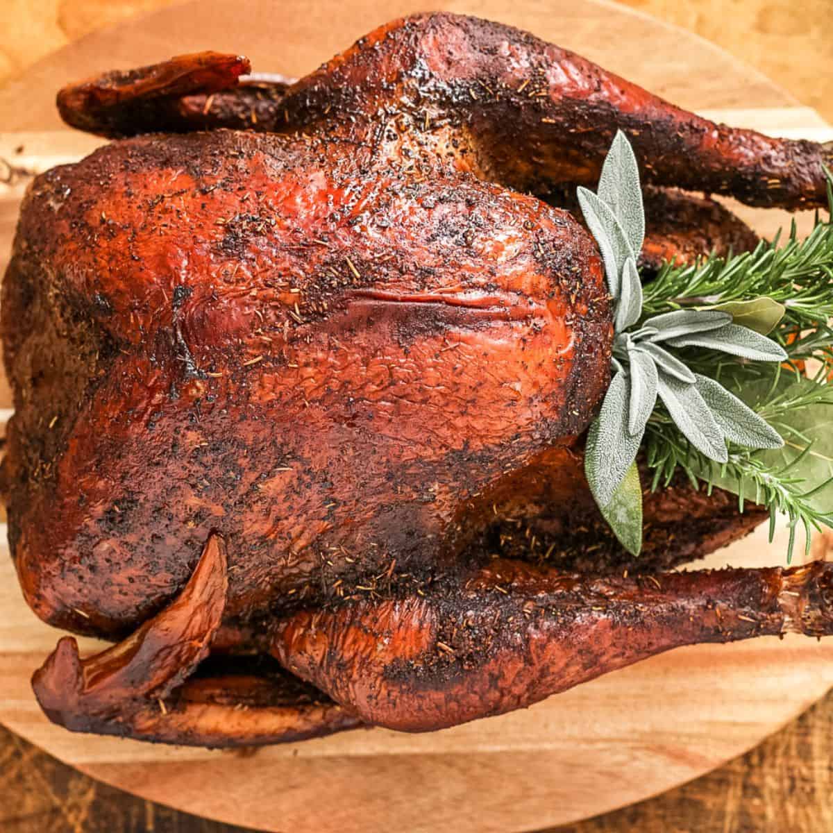 a whole smoked turkey on a cutting board