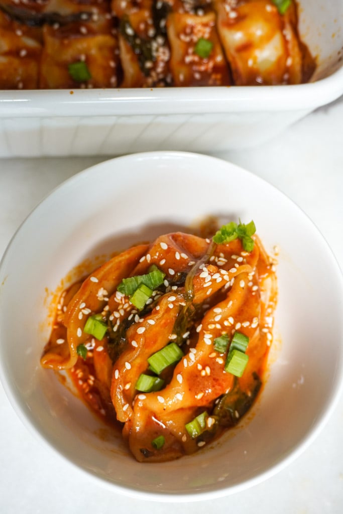 baked potstickers in a curry sauce in a bowl
