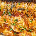 baked dumpling tray with red curry sauce