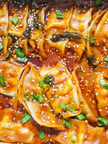 baked dumpling tray with red curry sauce