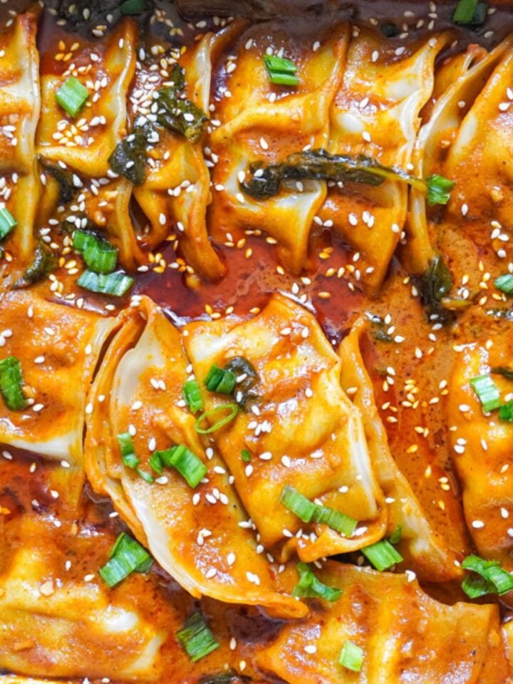 baked dumpling tray with red curry sauce