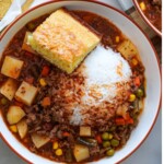 bowl of beef and veggie soup with a scoop of