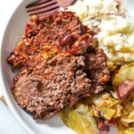 meatloaf plated with cabbage and mashed potatoes