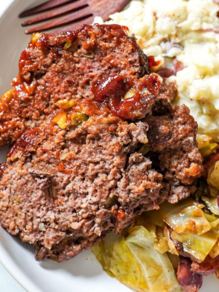 meatloaf plated with cabbage and mashed potatoes