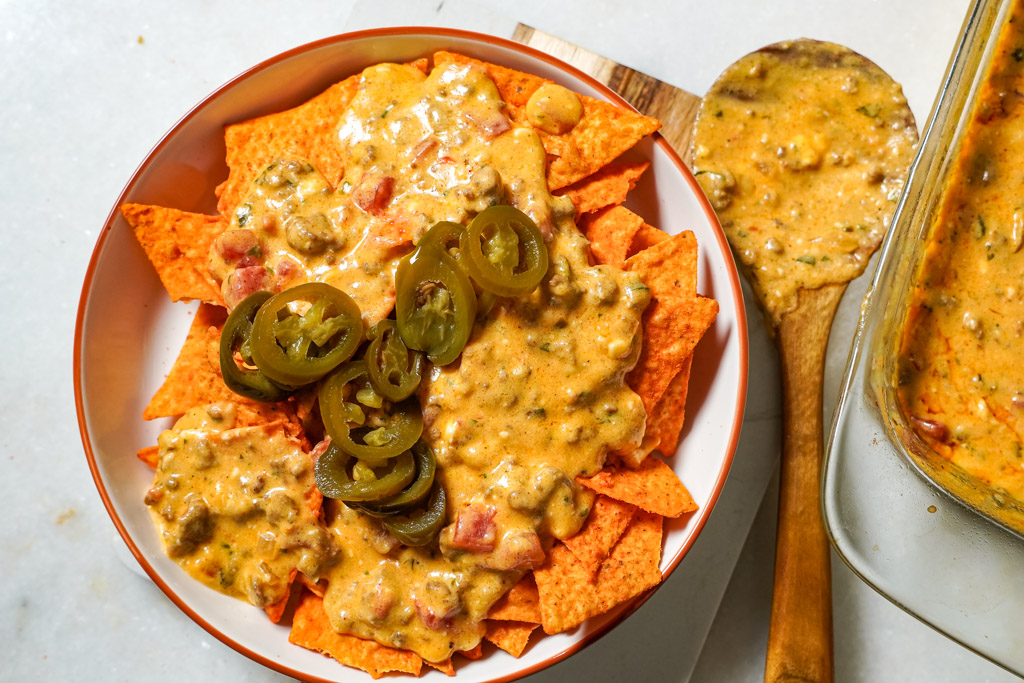rotel dip with ground beef plated with some nachos