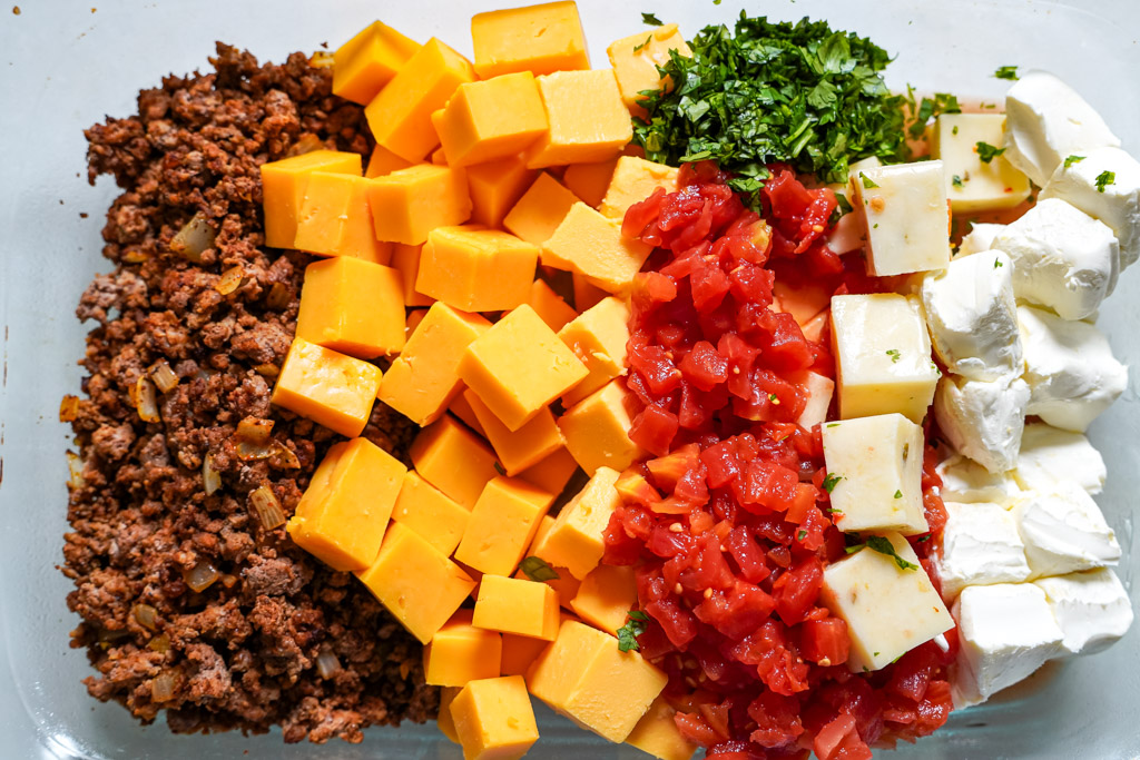 cheese and ground beef in a baking dish to make rotel dip
