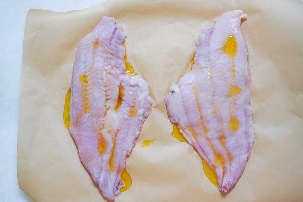 raw catfish with olive oil drizzled on it
