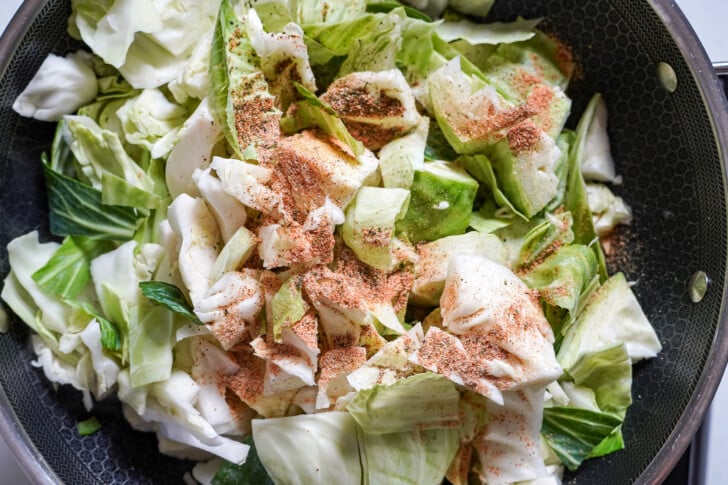 cooking cabbage in a pot with seasoning on it