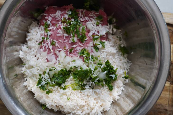 ground beef and rice in a bowl to make albondigas