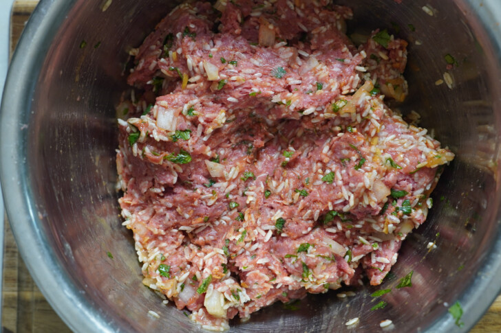 ground beef and rice in a bowl to make albondigas