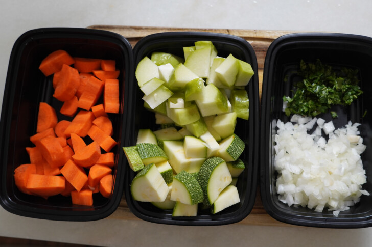 chopped carrots, zucchini, and onions in bowls