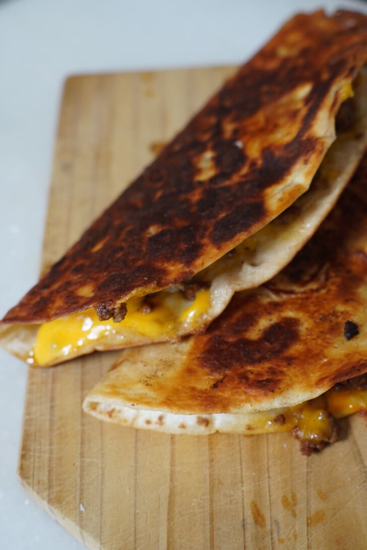 beef and cheese quesadillas on a cutting board