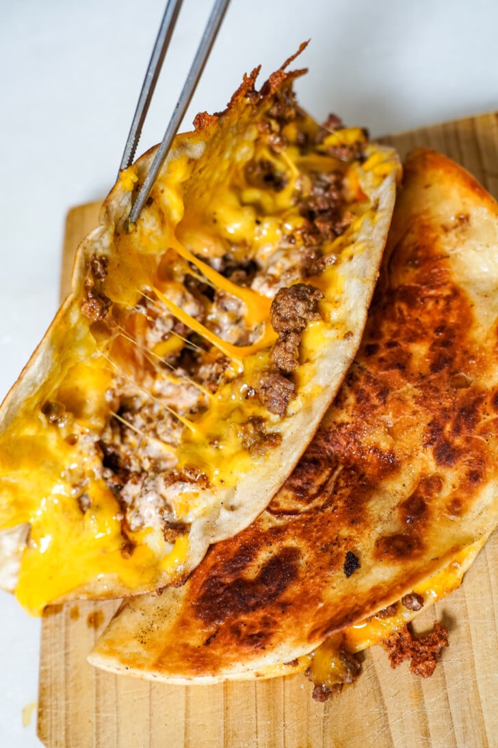 beef and cheese quesadillas on a cutting board