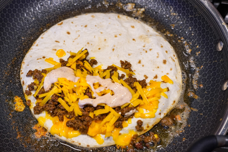 beef and cheese quesadilla in a skillet