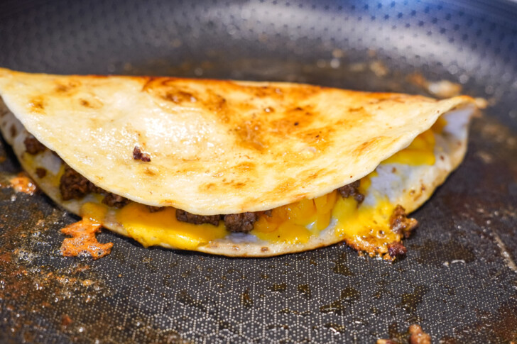 beef and cheese quesadilla in a skillet