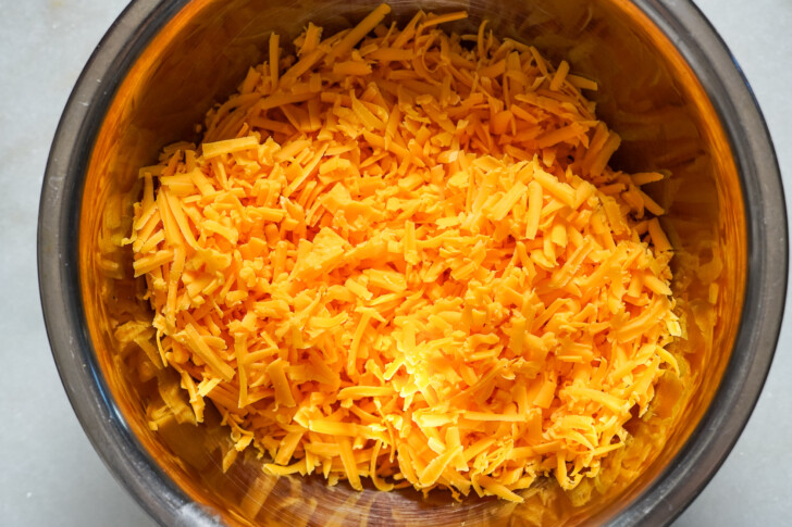 shredded cheddar cheese in a bowl