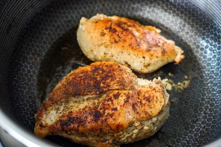 searing chicken in a skillet until golden brown
