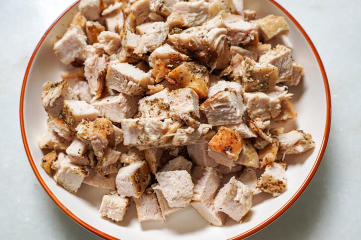Chicken cut up in a white bowl