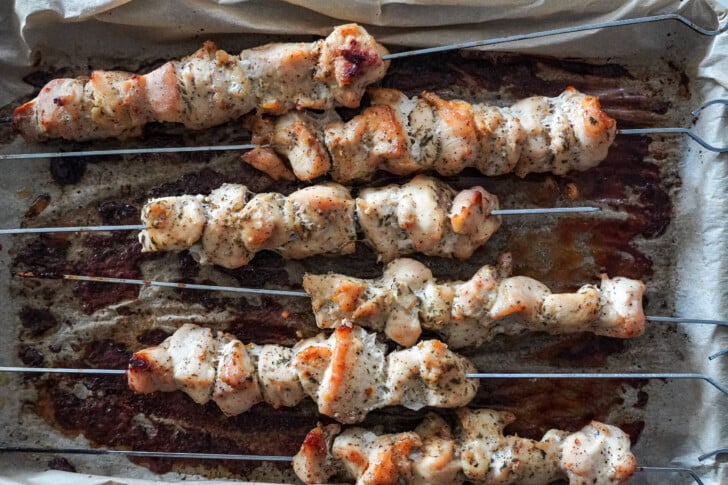 baked chicken skewers on a sheet pan