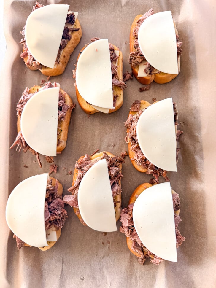 cheese on top of a roast beef sandwich