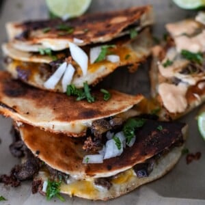 steak tacos on a tray with onion and cilantro