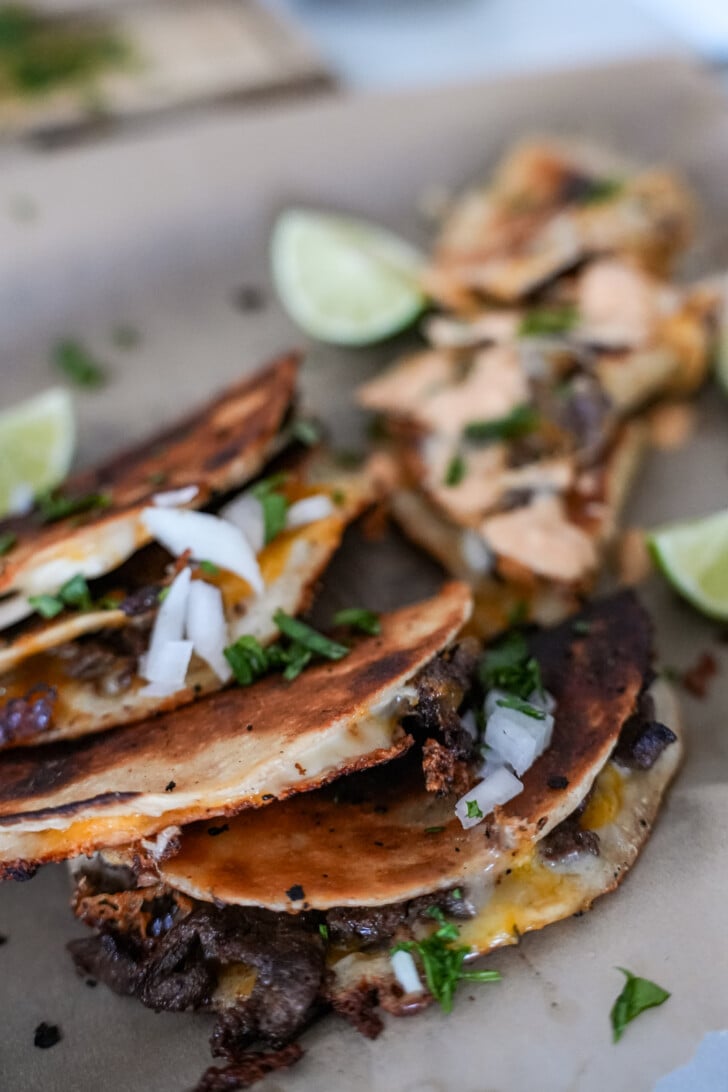 steak tacos on a tray with cilantro and onion