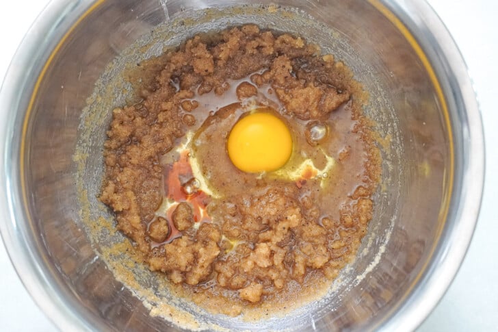 brown sugar and white sugar in a bowl with an egg