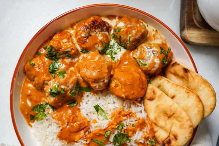meatballs in butter chicken sauce in a bowl
