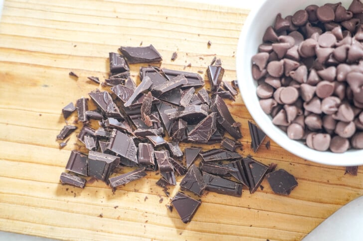 chocolate chips and chocolate chopped on a board