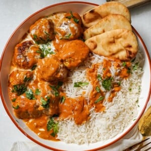 meatballs in butter chicken sauce in a bowl