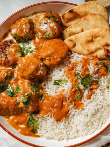 meatballs in butter chicken sauce in a bowl